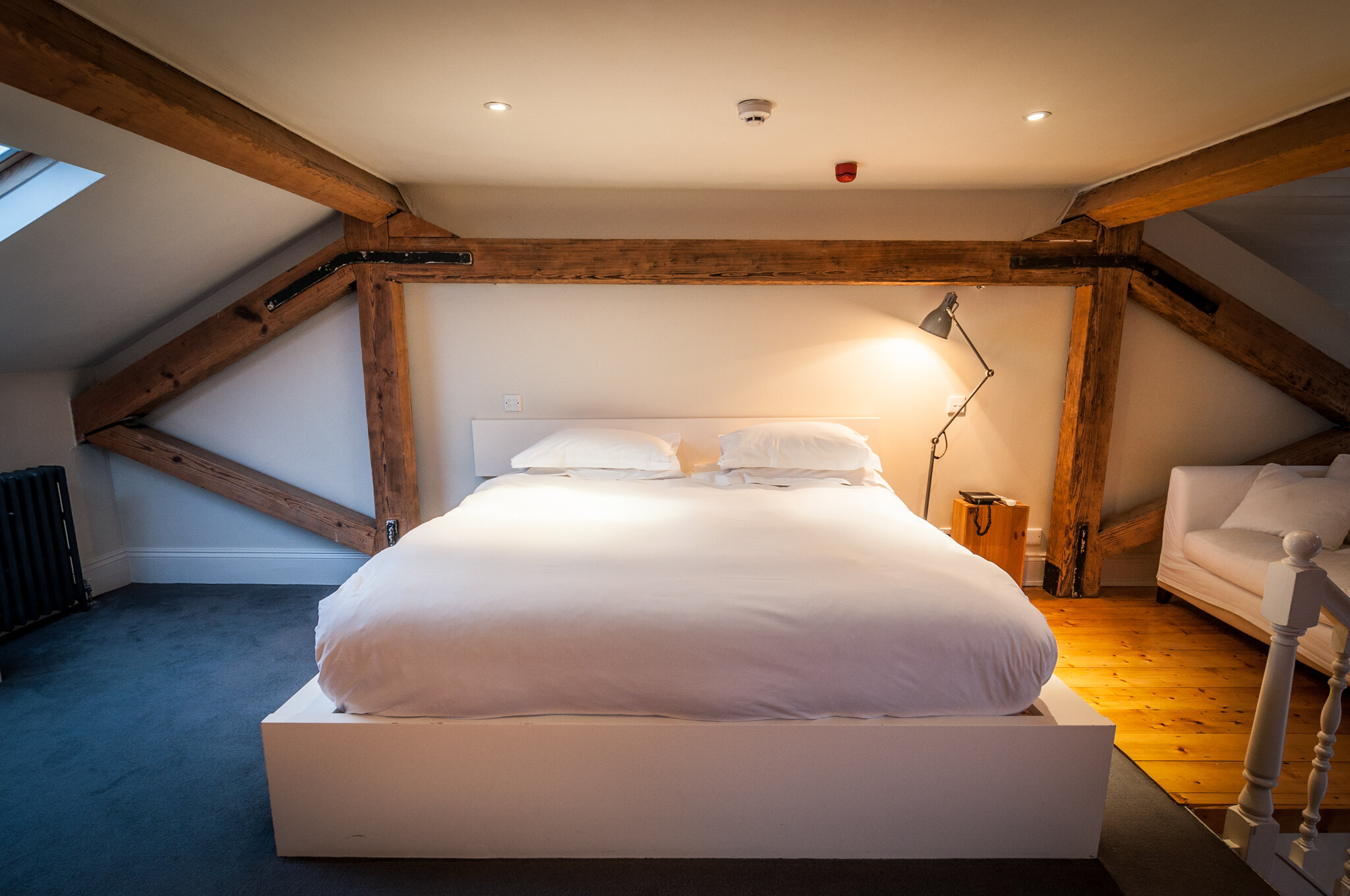 Kelly’s Hotel is one of the top boutique hotels in Dublin showing room with old wood beams