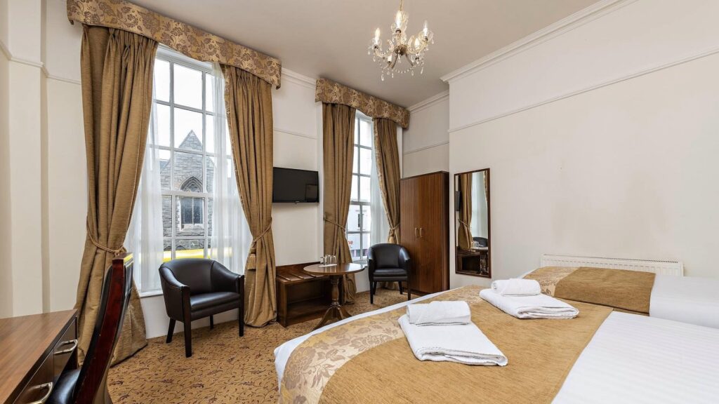 Castle Hotel master bedroom with windows at Dublin Townhouse hotels accommodations